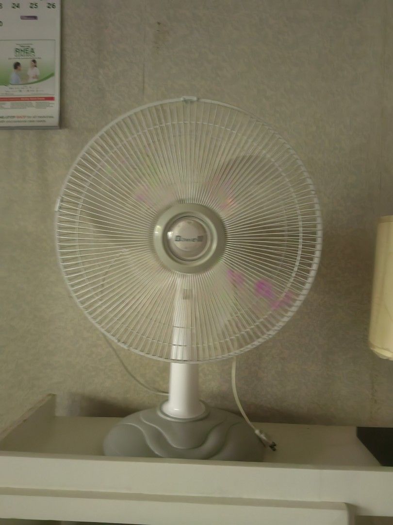Dowell Electric Desk Fan (Category: Other Home Appliances) located in Makati City. Submitted by donald1983 (Listing ID 1466973761, Image 1). Description: - Pick up: Makati - RFS: for me ndi sya malakas buga ng hangin - Color: White and grey with transparent pinkish blades - Design: Standard circular grill with a sturdy round plastic base - Controls: Easy-to-use mechanical button switch panel - Size: Compact and space-saving, ideal for tables, cou