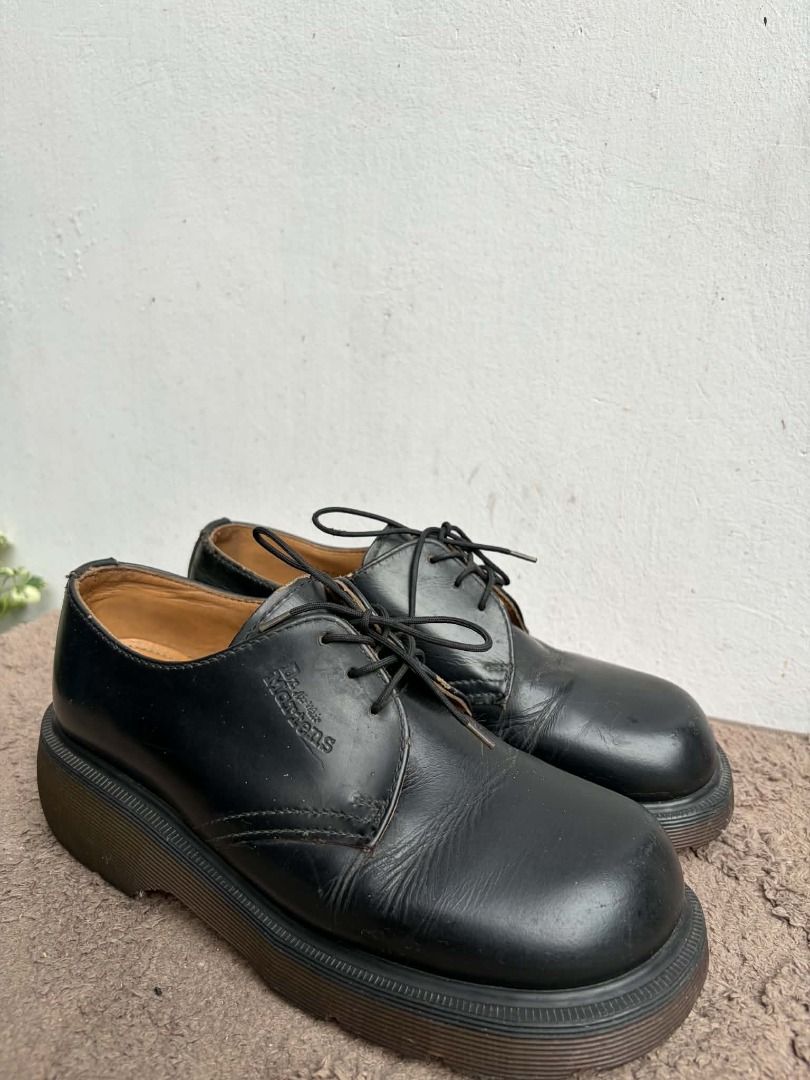 Dr. Martens Black Platform Derby Shoes (Category: Loafers) located in Naguilian. Submitted by vincesebastian (Listing ID 1467068589, Image 1). Description: - Brand: Dr. Martens - Made in England - Style: Black leather platform shoes with chunky soles and lace-up closure - Design: Classic round toe with stamped logo near the laces - Condition: Good, solid build with natural leather creasing from normal wear - Flaws: Light wear on the inner lining,