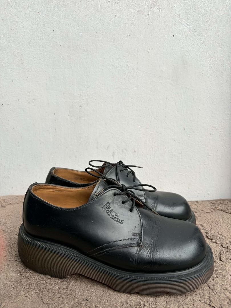 Dr. Martens Black Platform Derby Shoes (Category: Loafers) located in Naguilian. Submitted by vincesebastian (Listing ID 1467068589, Image 2). Description: - Brand: Dr. Martens - Made in England - Style: Black leather platform shoes with chunky soles and lace-up closure - Design: Classic round toe with stamped logo near the laces - Condition: Good, solid build with natural leather creasing from normal wear - Flaws: Light wear on the inner lining,