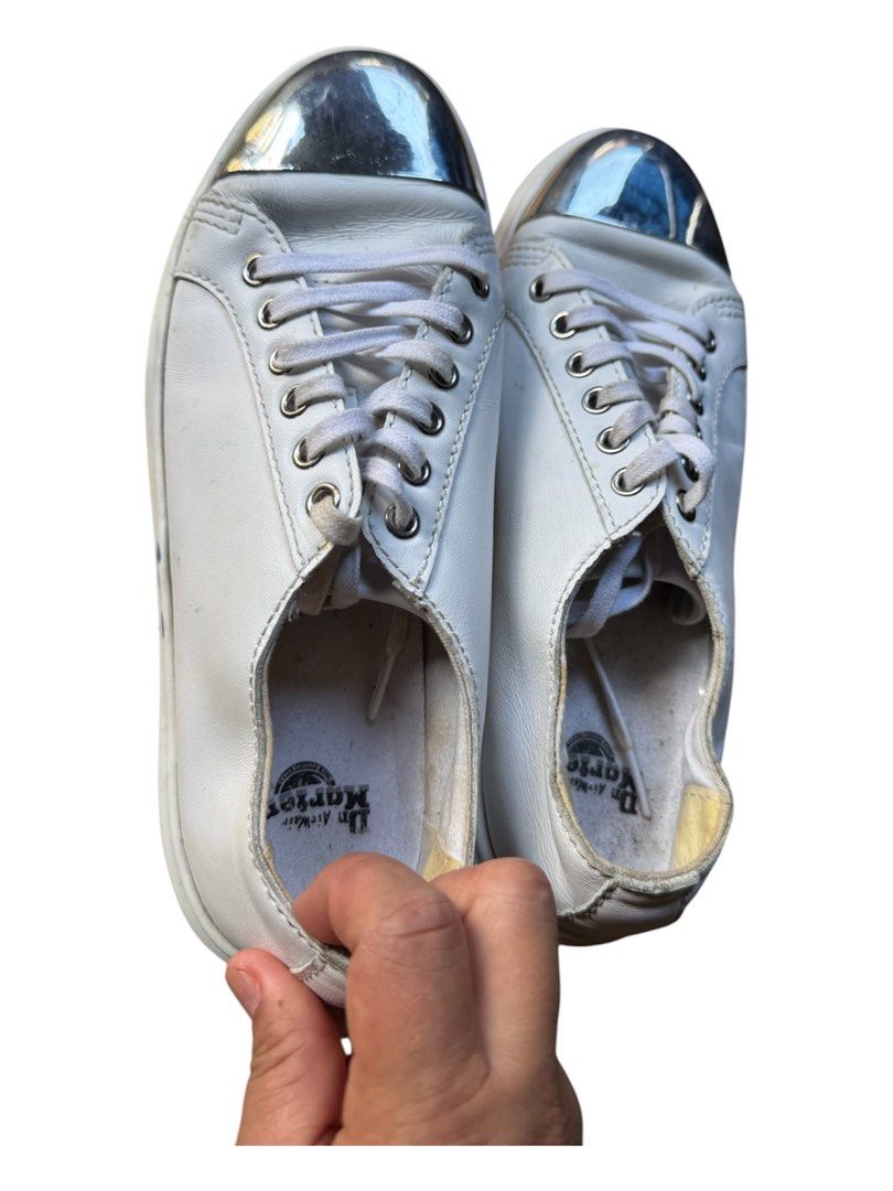 Dr. Martens White Metallic Cap Toe Leather Sneakers (Category: Sneakers) located in Lapu-Lapu City. Submitted by XueBaiGuang (Listing ID 1467062953, Image 1). Description: - Brand: Dr. Martens - Color: White with silver metallic cap toes - Style: Chunky platform sneakers with white laces and debossed tongue logo - Interior: Branded Dr. Martens insoles - Condition: Pre-loved with minor scuffs on the silver toes and slight wear inside the collars -