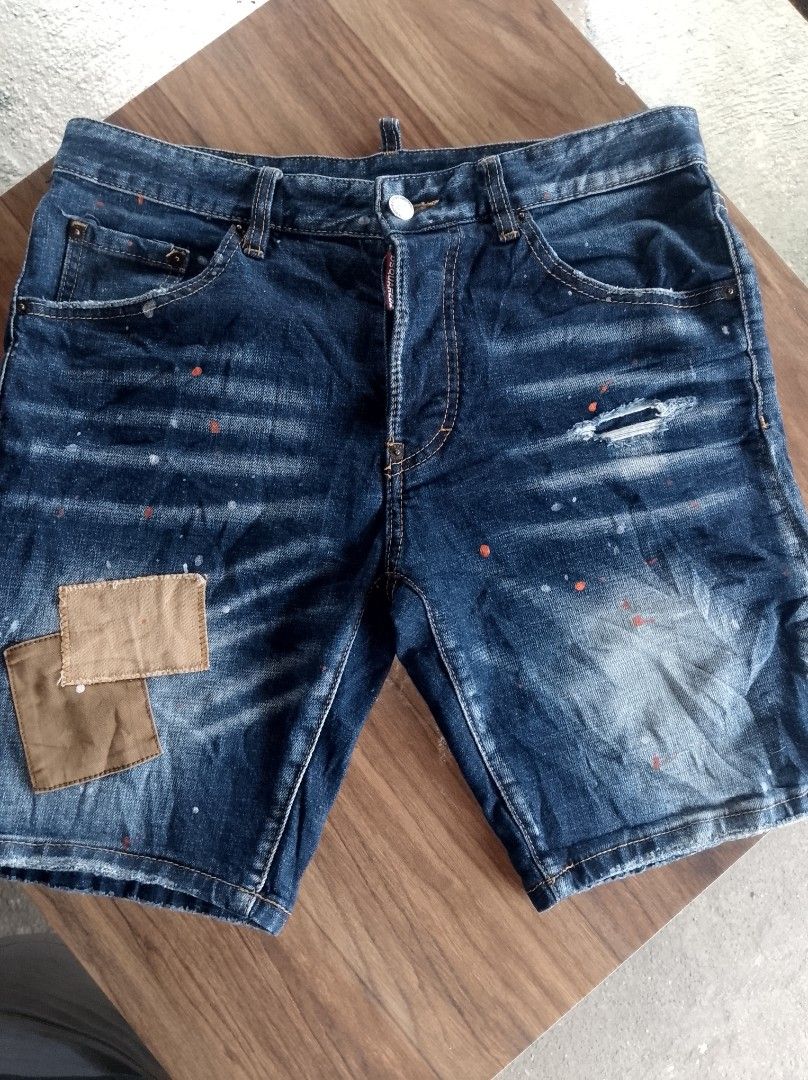 Dsquared2 Denim Shorts Size 46 (Category: Shorts) located in Kapalong. Submitted by aliclothesfinds21 (Listing ID 1467091956, Image 1). Description: - Brand: Dsquared2 - Size: 46 (Made in Italy) - Material: 98% Cotton, 2% Elastane (Regular fit) - Wash: Dark wash denim - Details: Trendy paint splatters, stylish distressing, and unique fabric patches - Hardware: Classic button fly and branded hardware - Back: Signature rear label patch - Condition: