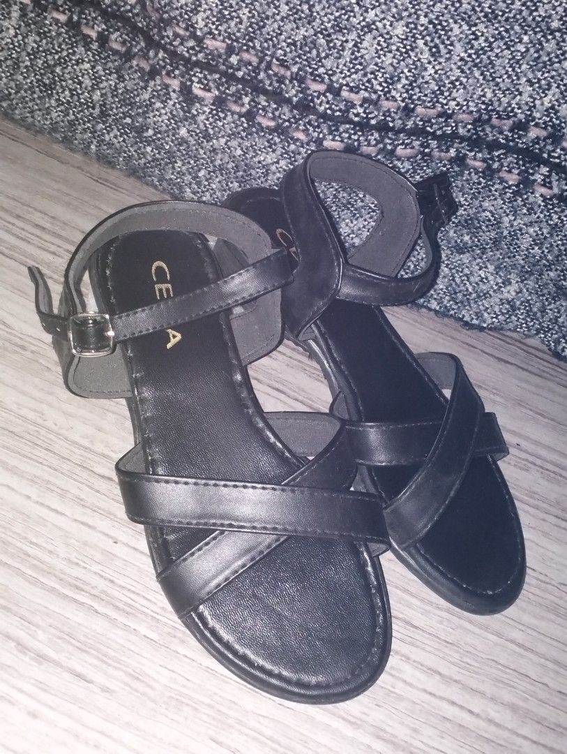 Duty Sandal (Category: Wedges) located in Caloocan City. Submitted by newnrenewfinds (Listing ID 1467134419, Image 1). Description: - Brand: Cena - Color: Classic black finish - Style: Crisscross toe straps with adjustable ankle buckle - Heel: Comfortable low wedge, perfect for all-day wear.