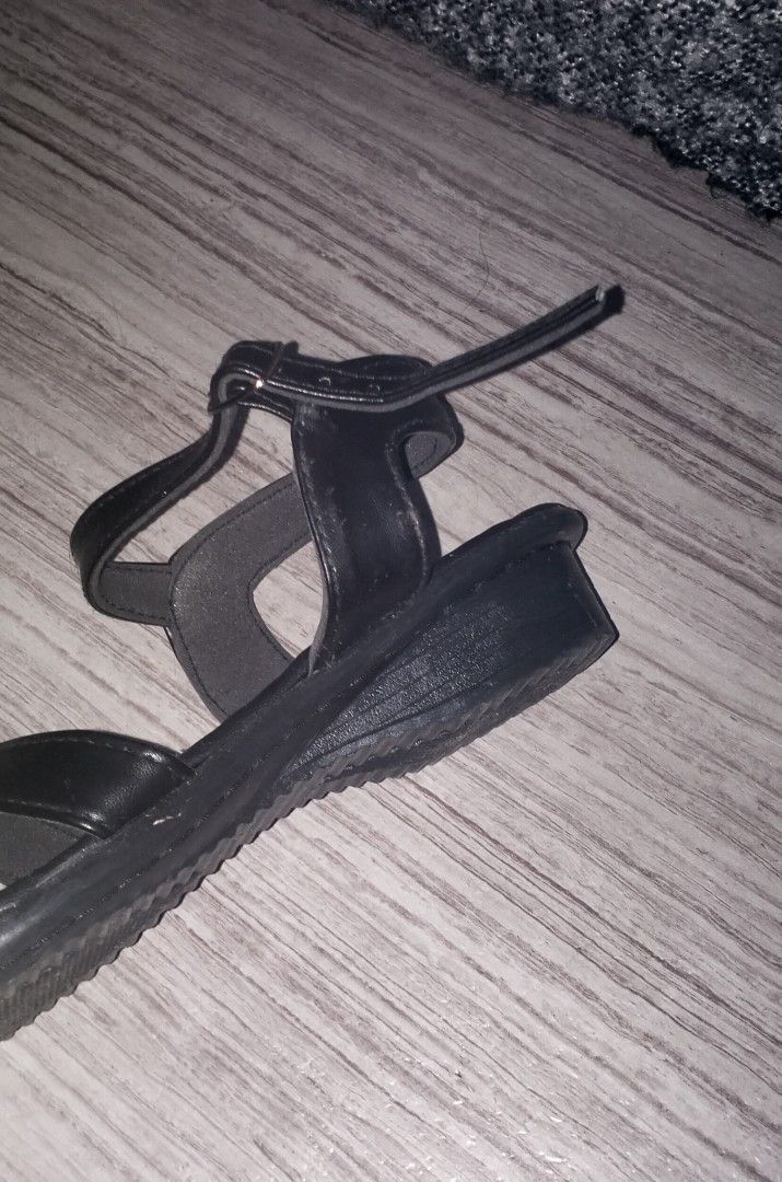 Duty Sandal (Category: Wedges) located in Caloocan City. Submitted by newnrenewfinds (Listing ID 1467134419, Image 2). Description: - Brand: Cena - Color: Classic black finish - Style: Crisscross toe straps with adjustable ankle buckle - Heel: Comfortable low wedge, perfect for all-day wear.