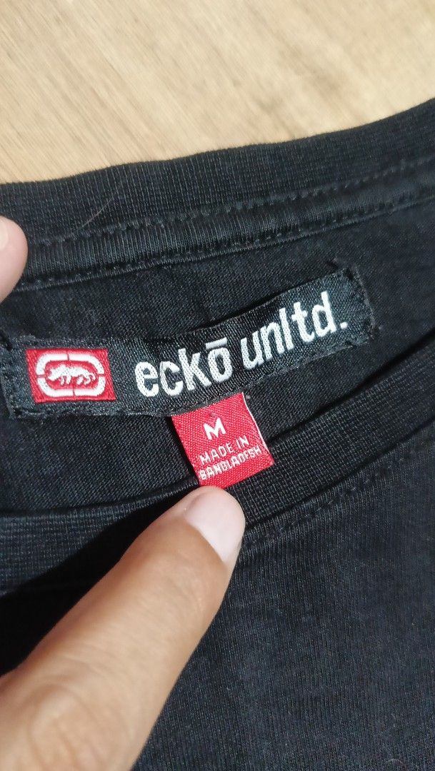 Eckō Unltd. Black Long Sleeve T-Shirt (Category: Tshirts & Polo Shirts ) located in Manila. Submitted by sweety_skwert (Listing ID 1467053746, Image 3). Description: - Brand: Eckō Unltd. - Style: Black long sleeve t-shirt with crew neck and standard fit - Graphic: Large white rhino print on -chest with branding - Size: Medium (made in Bangladesh) - Condition: Clean fabric with minimal signs of wear - Ideal for casual, everyday streetwear outfits 
