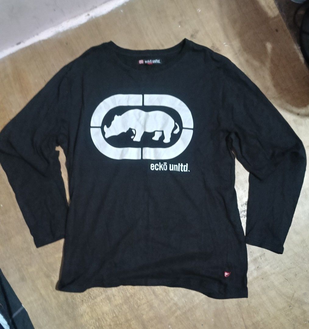 Eckō Unltd. Black Long Sleeve T-Shirt (Category: Tshirts & Polo Shirts ) located in Manila. Submitted by sweety_skwert (Listing ID 1467053746, Image 1). Description: - Brand: Eckō Unltd. - Style: Black long sleeve t-shirt with crew neck and standard fit - Graphic: Large white rhino print on -chest with branding - Size: Medium (made in Bangladesh) - Condition: Clean fabric with minimal signs of wear - Ideal for casual, everyday streetwear outfits 