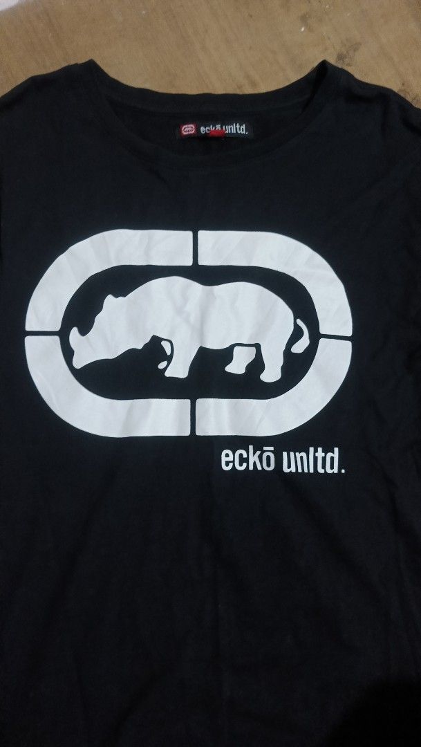 Eckō Unltd. Black Long Sleeve T-Shirt (Category: Tshirts & Polo Shirts ) located in Manila. Submitted by sweety_skwert (Listing ID 1467053746, Image 2). Description: - Brand: Eckō Unltd. - Style: Black long sleeve t-shirt with crew neck and standard fit - Graphic: Large white rhino print on -chest with branding - Size: Medium (made in Bangladesh) - Condition: Clean fabric with minimal signs of wear - Ideal for casual, everyday streetwear outfits 