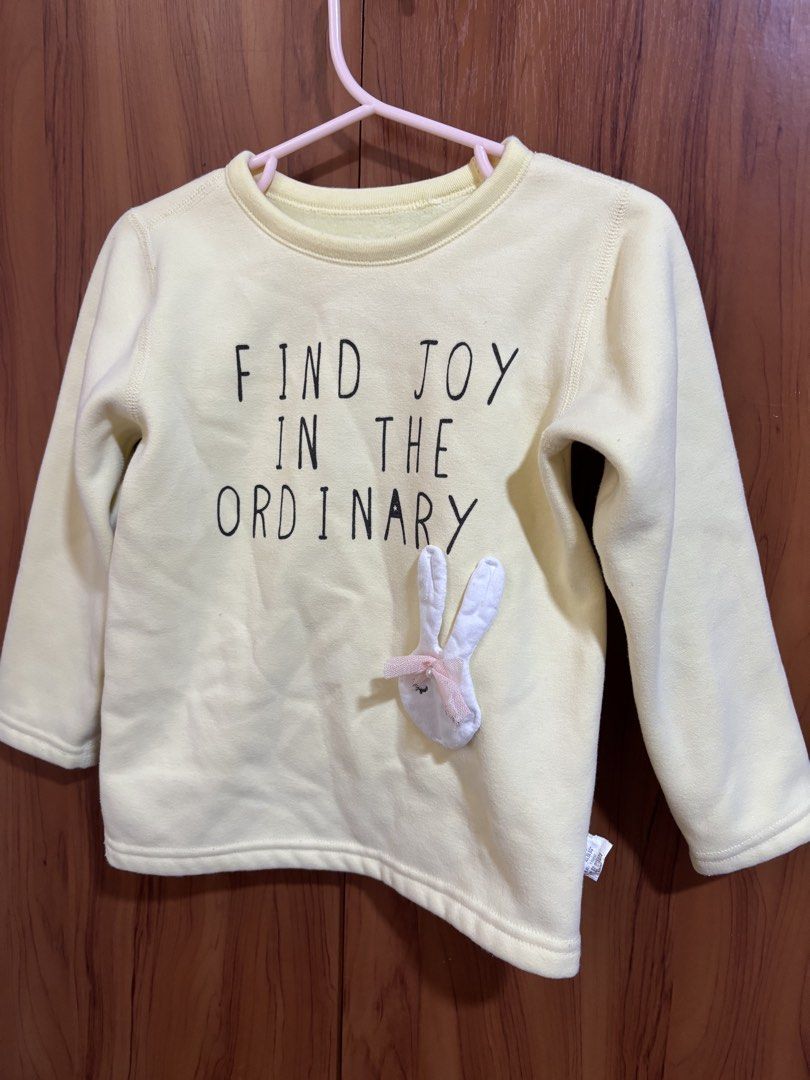 elala Yellow Sweatshirt Size (Category: Babies & Kids Fashion) located in Manila. Submitted by wardrobeinmnl (Listing ID 1467018182, Image 1). Description: - Brand: elala - Color: Bright yellow - Size: 110/60 - Material: Soft cotton blend outer with warm fuzzy plush lining - Design: 'Find Joy in the Ordinary' front print - Cute Detail: 3D bunny applique with a pink mesh bow near the hem.