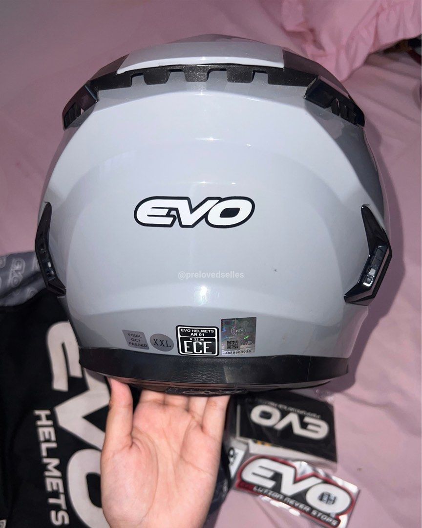 Evo AR-01 Full Face Motorcycle Helmet Gray (Category: Bicycles) located in Kawit. Submitted by prelovedselles (Listing ID 1467044795, Image 3). Description: Selling a brand new, completely unused EVO AR-01 full face helmet in cool gray. The plastic film is still on the visor. Specs: - Model: EVO AR-01 - Color: Cool Gray - Size: XXL on tag but can only fit 61-62cm (XL standard size) - Dual visor (outer clear lens and inner drop-down smoke visor) I