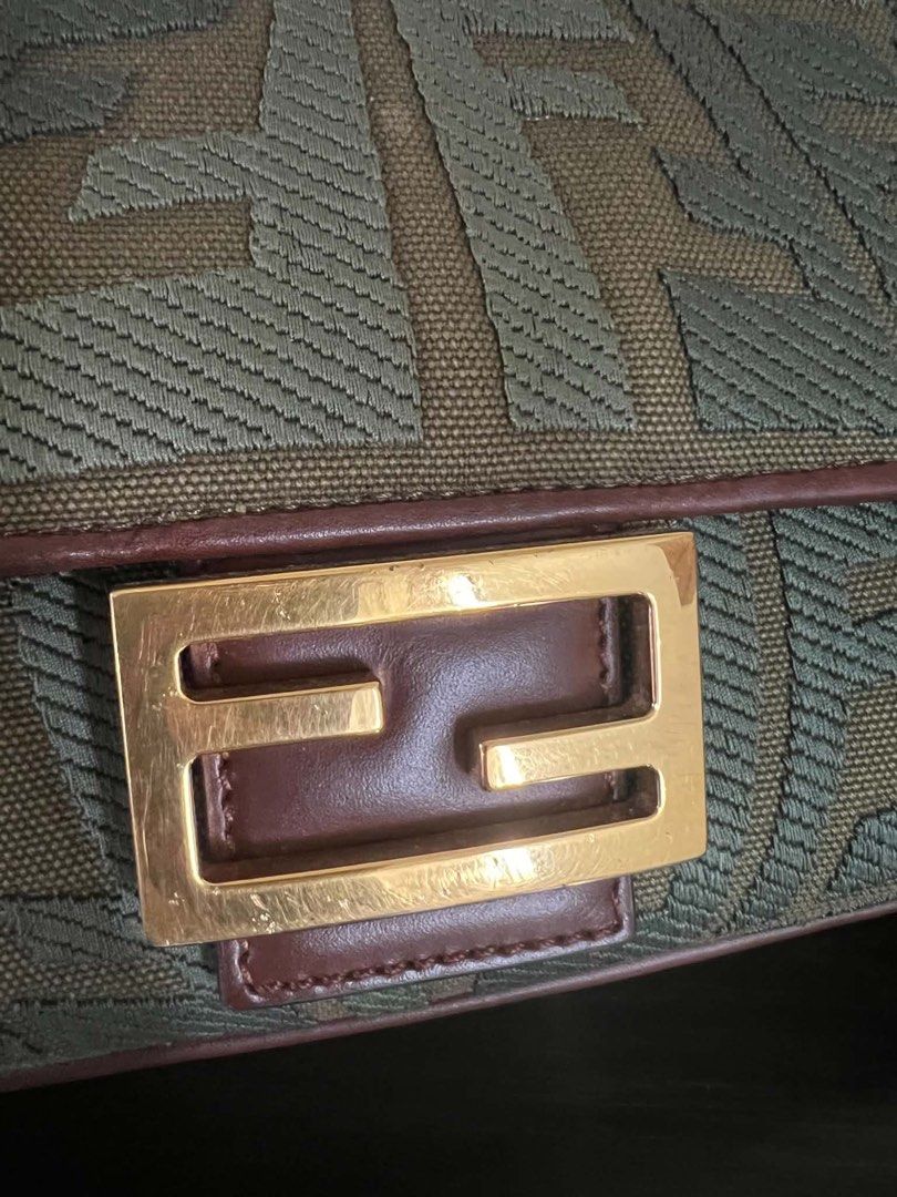 F Zucca Zucchino Canvas Shoulder Bag (Category: Luxury Bags & Wallets) located in Quezon City. Submitted by hellopatchi (Listing ID 1467003725, Image 2). Description: Fendi shoulder bag in green and brown Zucca monogram canvas. Brown leather trim and gold-tone hardware. Front flap closure featuring the signature FF logo metal buckle. Adjustable brown leather strap with engraved Fendi hardware clasps. Structured shape with compact interior. Minor 