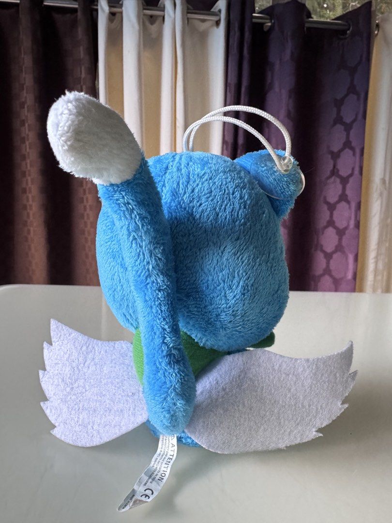 Fairy Tail Happy Plush Toy with Fish (Category: Plushies & Soft Toys) located in Caloocan City. Submitted by ciel31 (Listing ID 1467085488, Image 2). Description: - Character: Happy from Fairy Tail - Design: Bright blue fur, big white eyes, pink inner ears, and joyful expression - Accessories: Holding a blue fish with green seaweed - Features: White felt wings on the back and a white hanging loop on top.
