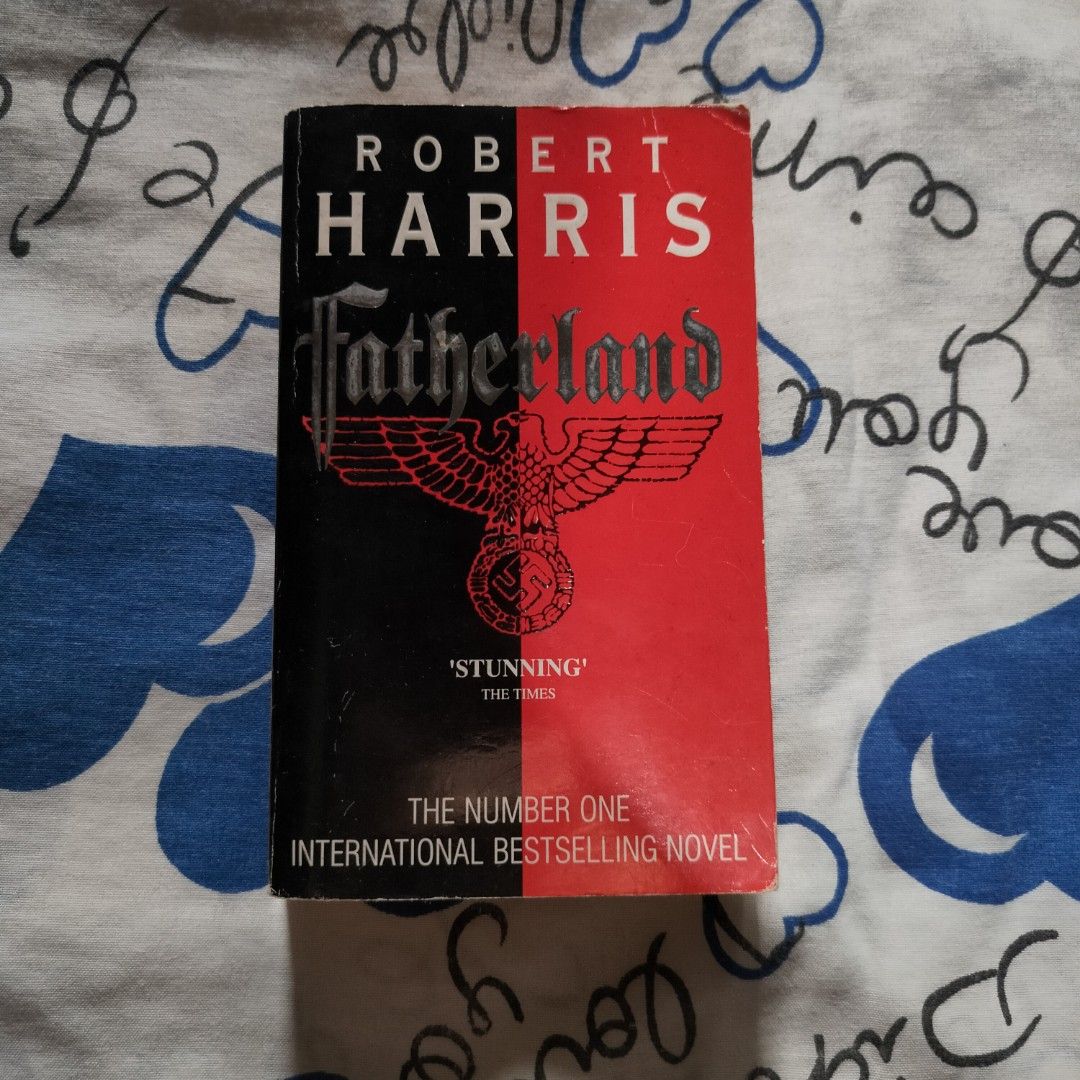 Fatherland by Robert Harris Novel Paperback (Category: Storybooks) located in Santa Maria. Submitted by shade.lost (Listing ID 1467050992, Image 1). Description: - Title: Fatherland by Robert Harris - Genre: Alternate history thriller (1964 Berlin) - Format: Paperback - ISBN: 0-09-926381-5 - Condition: Pages are yellowed due to age; cover has edge wear and creasing along the spine - Binding: Intact and sturdy for reading.