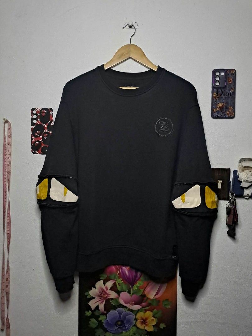 Fendi "Bag Bugs" Monster Line (Category: Luxury Apparel) located in Quezon City. Submitted by yaseen73 (Listing ID 1467163993, Image 1). Description: Authentic Fendi Monster Line "Bag Bugs" SweatShirt Dark Gray CrewNeck 2013 Made in Italy - Medium - Width 22 - Length 27 - Carpetize Sleeve Logo - Heavy Weight - Zippered Sleeve Details Yellow and White Eye Accent - 9.5/10 Color Rate - With Minimal Marks of Usage But Not Barely Visible - Pre Owned -