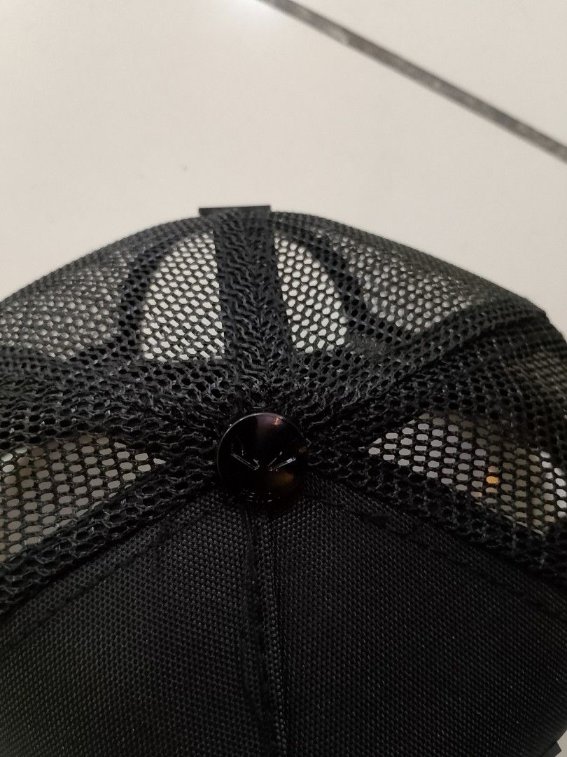 Fen di Monogram Eyes Black Trucker Cap (Category: Caps & Hats) located in Quezon City. Submitted by viaggo.travels (Listing ID 1467037462, Image 2). Description: - Brand: Fen. di - Color: Classic Black with Yellow Eye rubberized patch - Style: Trucker cap with breathable mesh back panels - Details: Embossed FF monogram pattern on the brim with original sticker - Hardware: Adjustable back strap featuring a small Fendi logo plate - Interior: Brande
