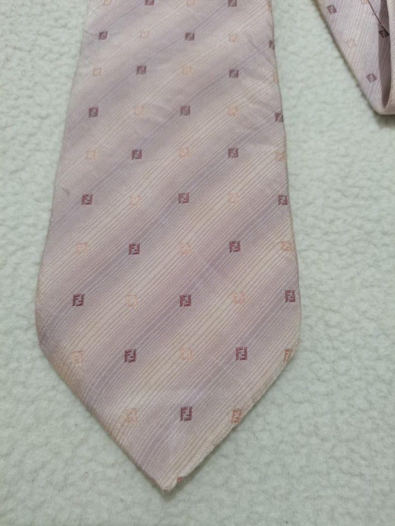 Fendi Vintage Silk Monogram Zucca Micro-Pattern Necktie (Category: Ties) located in Santa Cruz. Submitted by oddpenguin-4575 (Listing ID 1467066446, Image 3). Description: • Brand: Fendi • Country of Origin: Made in Italy • Material: 100% Pure Silk (Seta / Soie / Silk Seide) • Color Palette: Soft, elegant dusty pink / lavender-tinted rose base accented with micro-embroidered Zucca logos in muted plum and tan tones. • Pattern: Diagonal tonal jacqu