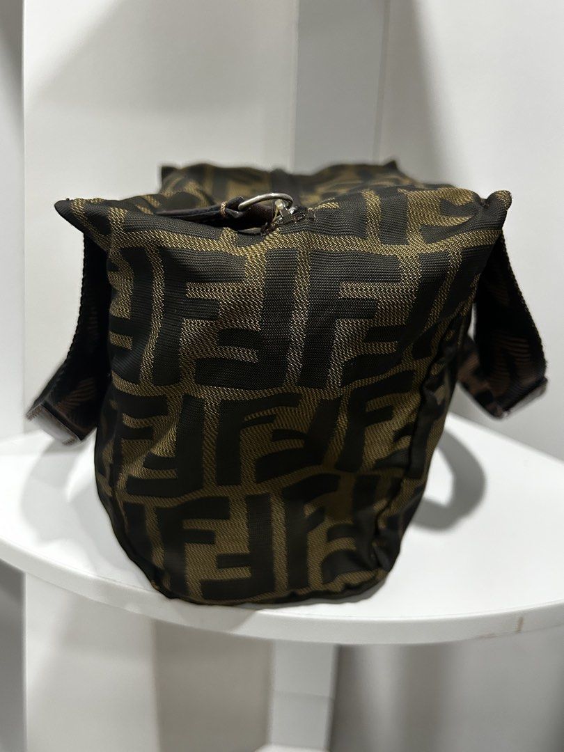 Fendi Zucca Print Mini Handbag (Category: Luxury Bags & Wallets) located in Rizal. Submitted by bebangel (Listing ID 1467100023, Image 3). Description: - Authentic Fendi handbag featuring the iconic brown and black Zucca monogram pattern - Compact and practical design, perfect for carrying daily essentials - Comfortable double fabric handles with stylish branded strap details - Secure top zipper closure equipped with a convenient leather pull tab