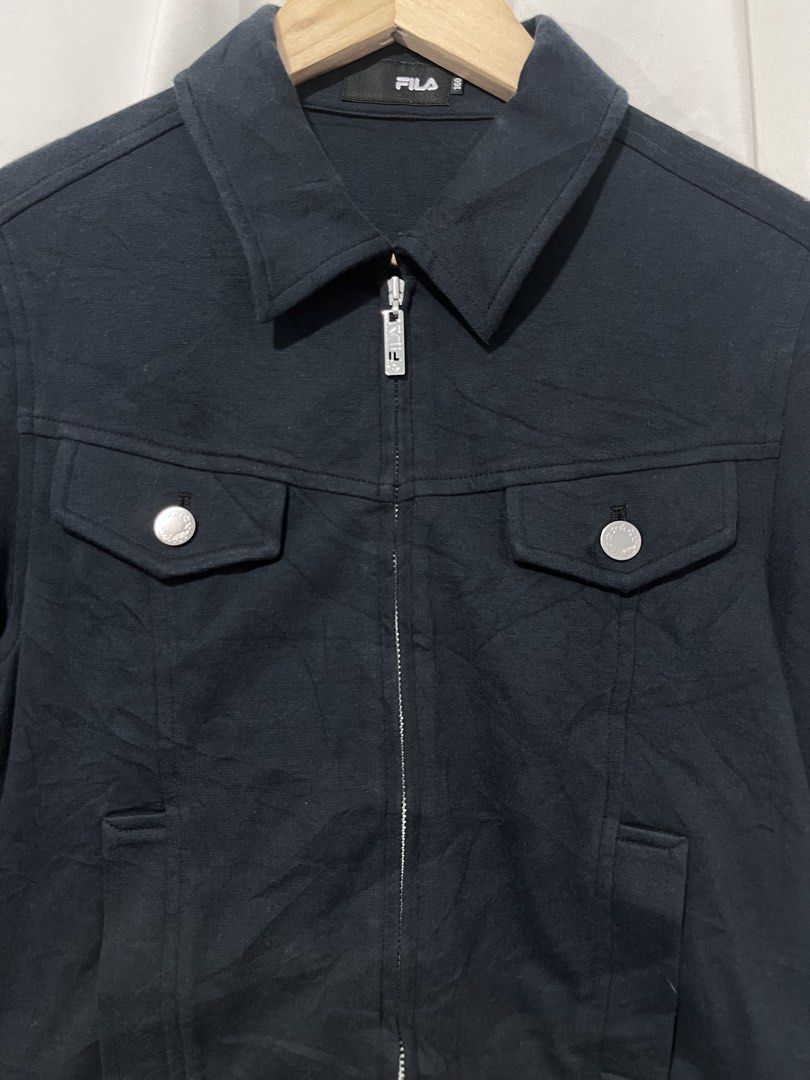 Fila Black Zip Up Jacket Size 160 (Small) (Category: Coats, Jackets and Outerwear) located in Baguio. Submitted by miisthyshop.ph (Listing ID 1467130551, Image 3). Description: - Brand: Fila - Color: Black - Size: 160 (fits Small) - Style: Zip-up jacket with classic collar and front buttoned chest pockets - Details: Custom Fila zipper pull and inner red, white, and blue stripe trim along the hem - Condition: Excellent pre-loved condition, clean a