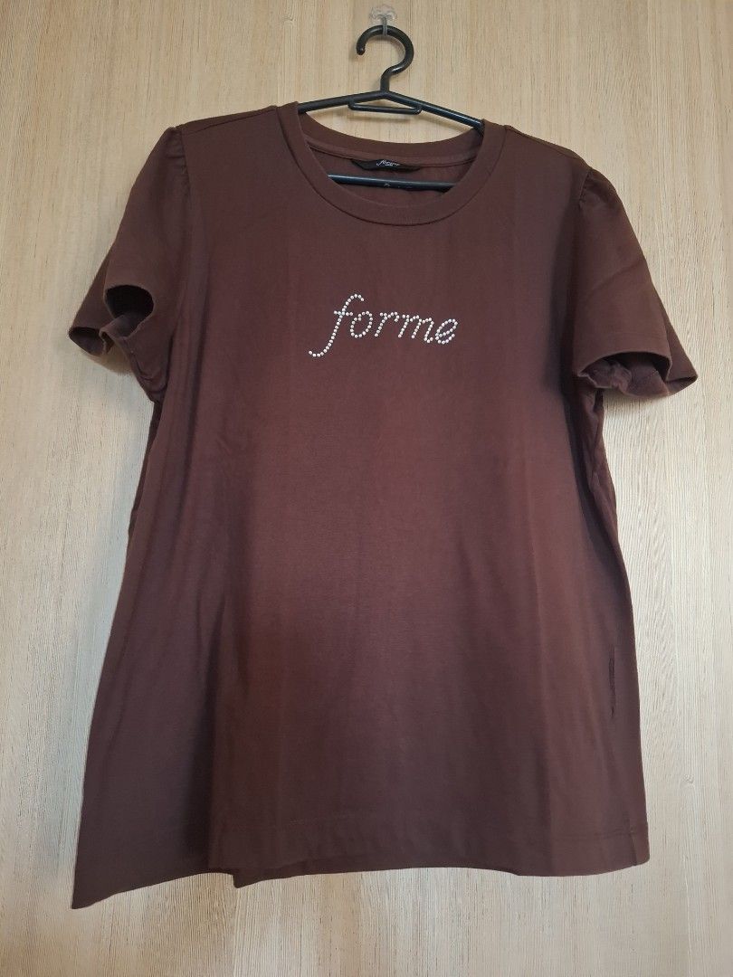 Forme Brown Blouse (Category: Shirts) located in Rizal. Submitted by mirisica (Listing ID 1467136688, Image 1). Description: - Brand: Forme - Size: Large - Color: Brown - Design: Rhinestone 'forme' script graphic on chest, plain back - Fit/Style: Short sleeves, classic crew neck, comfortable everyday fit - Material: Soft cotton - Condition: Good condition.