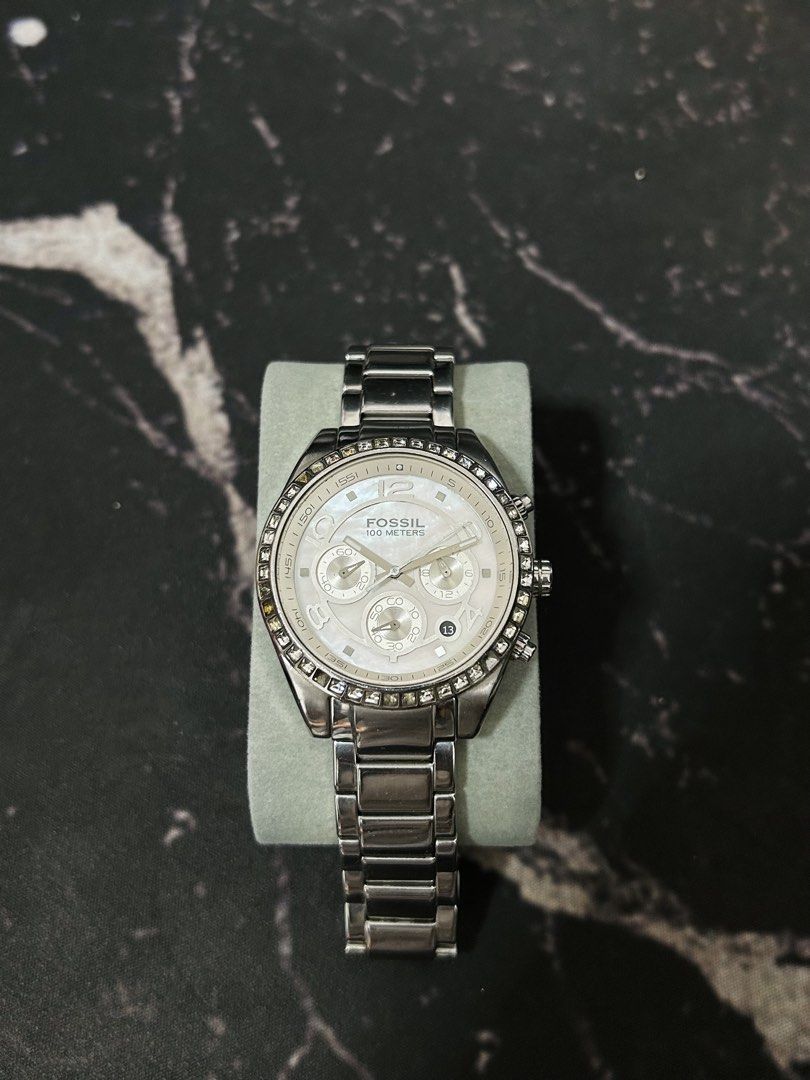 Fossil 100 Meters Chronograph Watch with Crystals (Category: Women's Watches) located in Manila. Submitted by jehielash (Listing ID 1467014993, Image 1). Description: ‼️ AUTHENTIC ‼️ - Brand: Fossil - Color: Silver tone with a shimmering mother-of-pearl dial - Features: Chronograph with 3 sub-dials, date window at 4 o'clock, and dazzling crystal bezel - Material: Stainless steel link bracelet with secure deployment clasp - Condition: Well-maintai