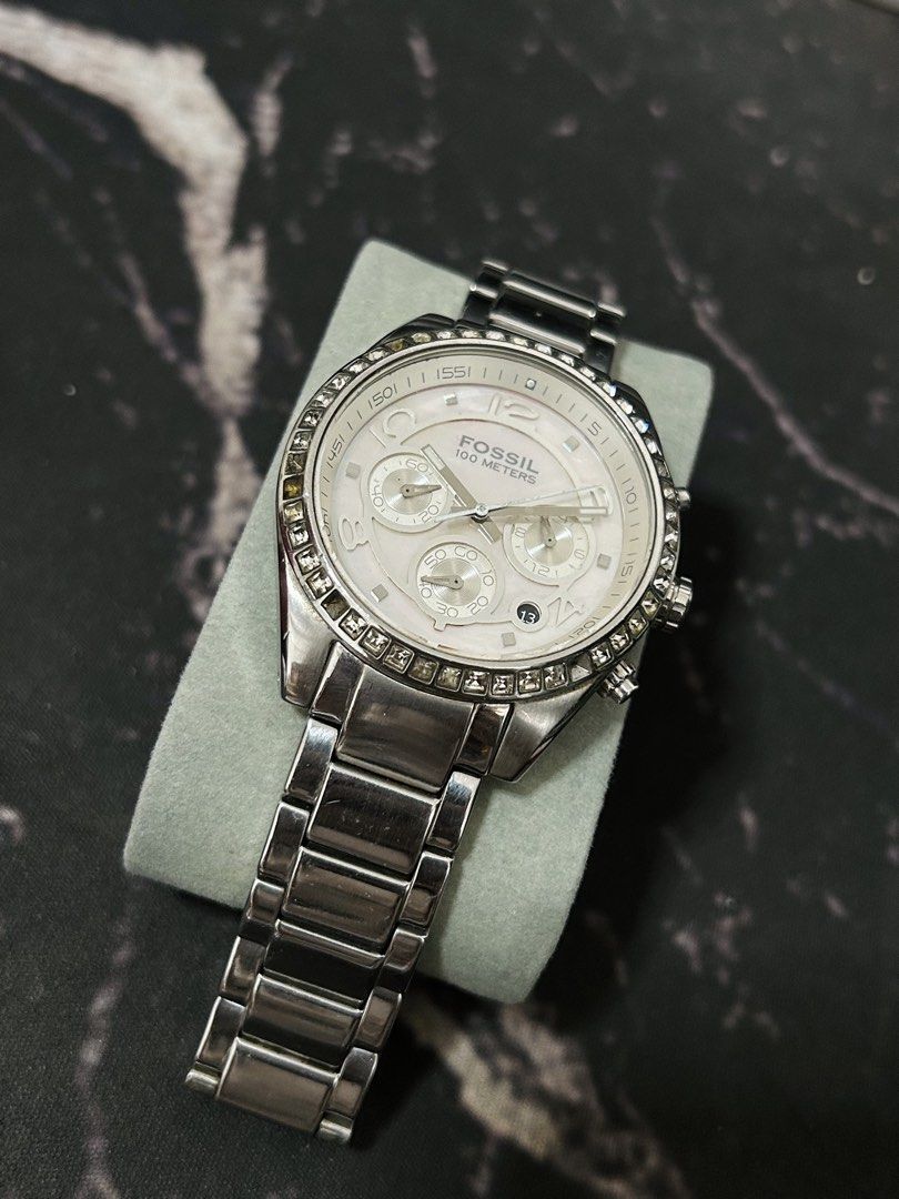 Fossil 100 Meters Chronograph Watch with Crystals (Category: Women's Watches) located in Manila. Submitted by jehielash (Listing ID 1467014993, Image 2). Description: ‼️ AUTHENTIC ‼️ - Brand: Fossil - Color: Silver tone with a shimmering mother-of-pearl dial - Features: Chronograph with 3 sub-dials, date window at 4 o'clock, and dazzling crystal bezel - Material: Stainless steel link bracelet with secure deployment clasp - Condition: Well-maintai