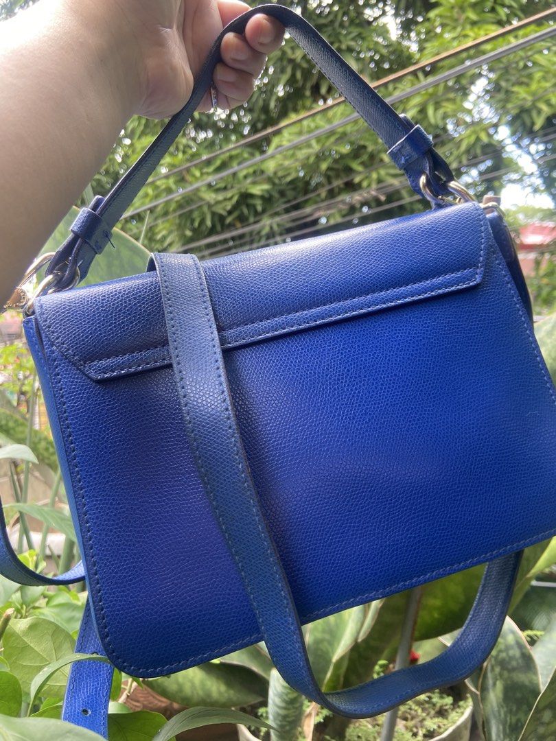 Furla Blue Crossbody Bag (Category: Cross-body Bags) located in Rizal. Submitted by baglovers10 (Listing ID 1467007705, Image 2). Description: - Brand: Furla - Color: Electric blue - Material: Textured leather - Hardware: Gold-tone with engraved logo - Closure: Structured flap - Strap: Adjustable with buckle detail - Size: Compact for daily essentials - Condition: Excellent.