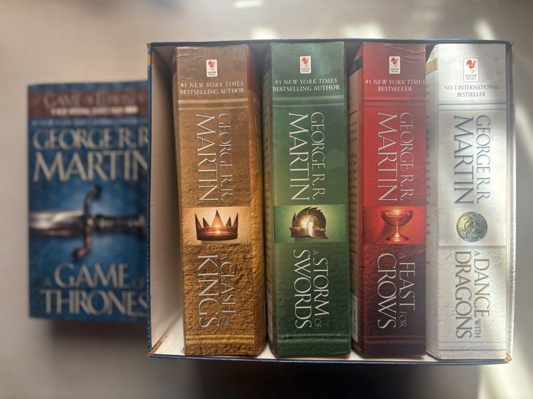 GAME OF THRONES WHOLE SET (Category: Storybooks) located in Davao. Submitted by flora7 (Listing ID 1467002306, Image 2). Description: - 1st book lang ang nalabas sa set, covered with a plastic patterned adhesive cover to secure, although nalabas hindi naman nabasa, it aged lang talaga because the bookshelf is exposed sa sun - the rest of the series never na nalabas never din nagamit/binasa so good as new sila - creases in the spine of the rest of