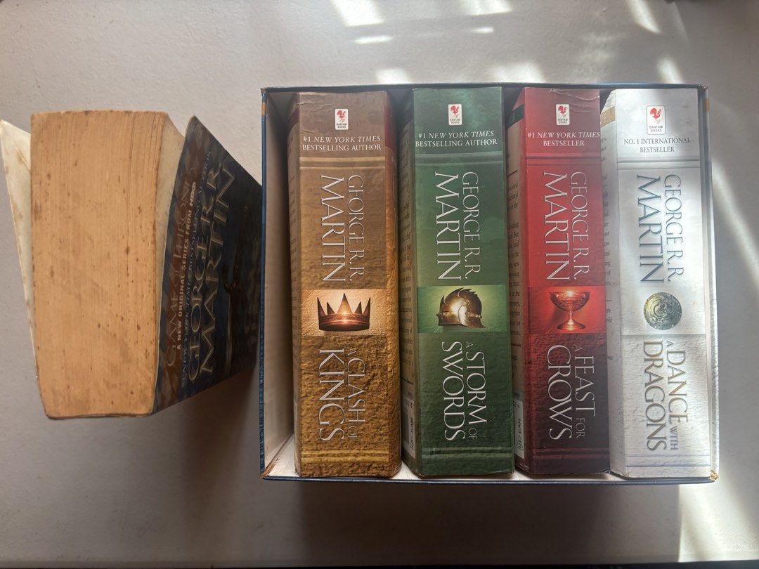 GAME OF THRONES WHOLE SET (Category: Storybooks) located in Davao. Submitted by flora7 (Listing ID 1467002306, Image 3). Description: - 1st book lang ang nalabas sa set, covered with a plastic patterned adhesive cover to secure, although nalabas hindi naman nabasa, it aged lang talaga because the bookshelf is exposed sa sun - the rest of the series never na nalabas never din nagamit/binasa so good as new sila - creases in the spine of the rest of