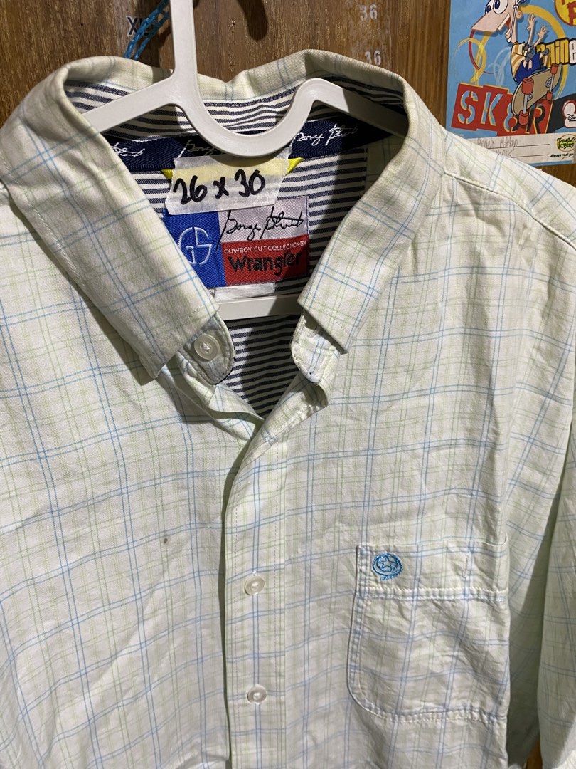 George Strait Wrangler Cowboy Cut Button Down Shirt (Category: Tshirts & Polo Shirts ) located in Imus. Submitted by frootiloots4103 (Listing ID 1467152987, Image 2). Description: - Brand: George Strait Cowboy Collection by Wrangler - Style: Short sleeve button-down shirt - Pattern: Light green and blue plaid - Details: Striped collar lining, blue contrasting tape inside, single chest pocket with blue embroidered logo - Size: 26" x 30" (based on 