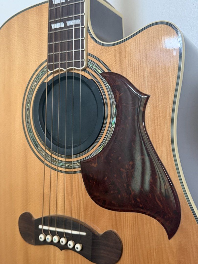 Gibson Acoustic Guitar (Category: Musical Instruments) located in Agoo. Submitted by rfgoodies (Listing ID 1467073527, Image 2). Description: - Gibson acoustic songwriter -Super copy - Aesthetics: Natural wood top, detailed rosette, dark back and sides with center stripe, and custom fretboard block markers - Hardware: Premium gold tuning pegs - Condition: Clean fretboard and smooth finish, well-maintained - Inclusions: Comes with a soundhole plug