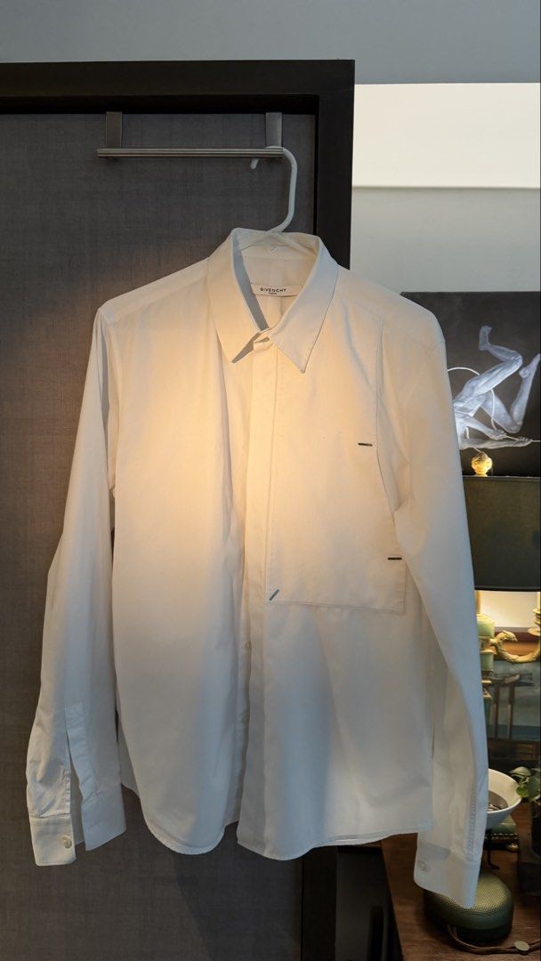 Givenchy Paris White Long Sleeve Shirt (Category: Formal Shirts) located in Makati City. Submitted by tomascz (Listing ID 1466983167, Image 1). Description: - Brand: Givenchy Paris - Color: Classic White - Style: Long-sleeve button-down with concealed placket - Details: Textured front bib with stylish metal bar hardware - Fit: Classic fit, fits true to size - Hem: Standard curved hemline - Condition: Used this a lot — has a lot of dark marks and 