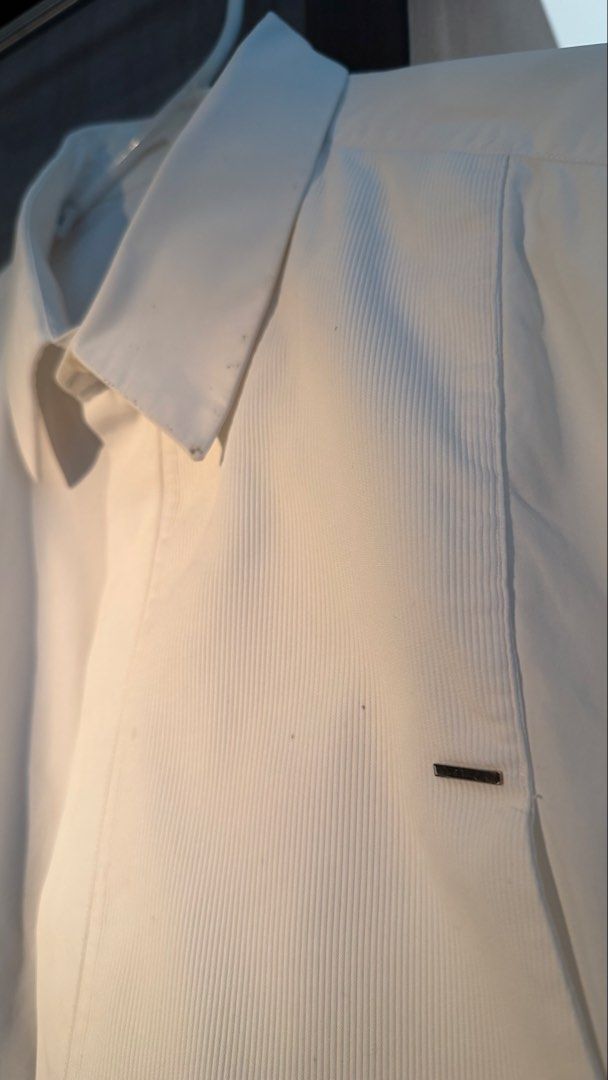 Givenchy Paris White Long Sleeve Shirt (Category: Formal Shirts) located in Makati City. Submitted by tomascz (Listing ID 1466983167, Image 2). Description: - Brand: Givenchy Paris - Color: Classic White - Style: Long-sleeve button-down with concealed placket - Details: Textured front bib with stylish metal bar hardware - Fit: Classic fit, fits true to size - Hem: Standard curved hemline - Condition: Used this a lot — has a lot of dark marks and 