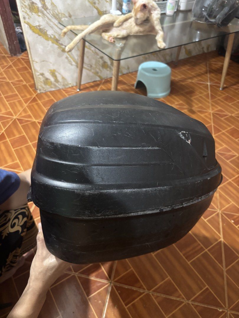 Givi Motorcycle Top Box with Base Plate (Category: Body Parts and Accessories) located in Binan City. Submitted by bearfinds (Listing ID 1467002826, Image 1). Description: 🛵 Black Givi motorcycle top box for Includes: - mounting base plate - bracket (fit for mio soulty) - 2 keys 📍 Spacious interior fits helmets and riding gear - Exterior shows visible scratches and surface wear - Reliable storage upgrade for daily commuting or long rides .