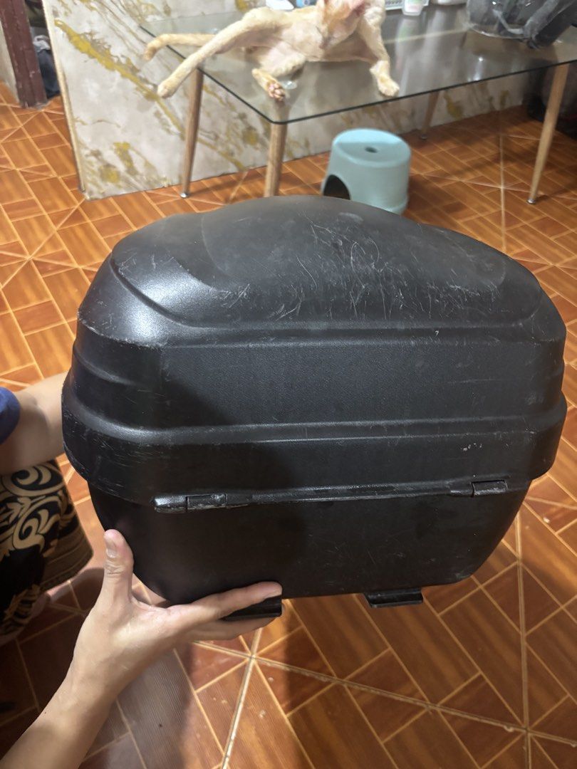 Givi Motorcycle Top Box with Base Plate (Category: Body Parts and Accessories) located in Binan City. Submitted by bearfinds (Listing ID 1467002826, Image 3). Description: 🛵 Black Givi motorcycle top box for Includes: - mounting base plate - bracket (fit for mio soulty) - 2 keys 📍 Spacious interior fits helmets and riding gear - Exterior shows visible scratches and surface wear - Reliable storage upgrade for daily commuting or long rides .