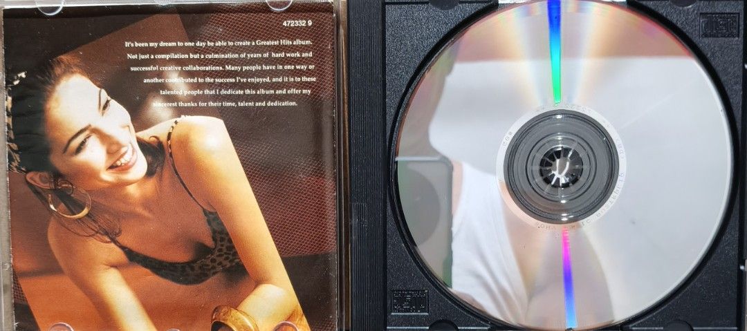 Gloria Estefan Greatest Hits Audio CD Epic Records (Category: CDs & DVDs) located in Manila. Submitted by ruelcabrer77078 (Listing ID 1467110397, Image 2). Description: - Artist/Album: Gloria Estefan Greatest Hits (Epic Records) - Tracklist: Includes 16 classic tracks like Conga, Dr. Beat, Words Get in the Way, and Always Tomorrow - Inclusions: Original jewel case and artwork booklets - Condition: Disc has minor markings in permanent marker on th