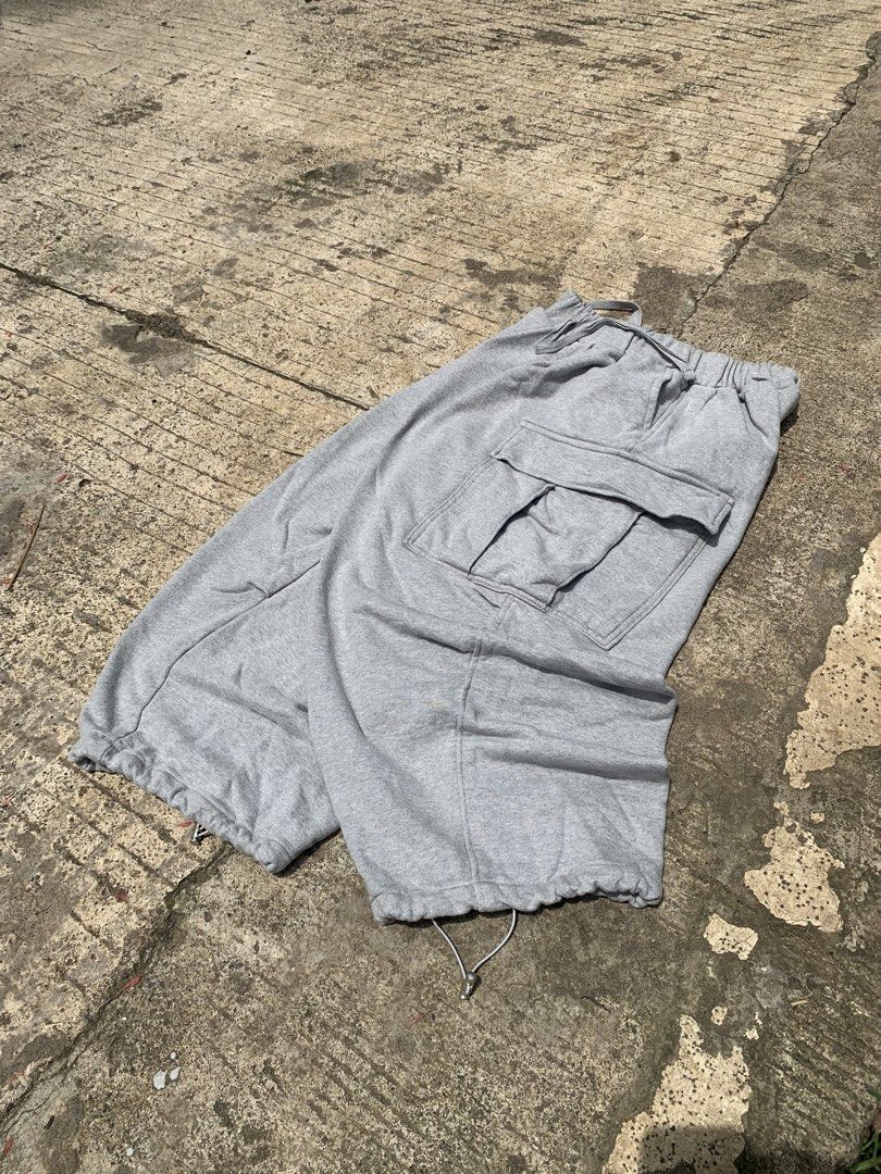 Grey Cargo Sweatpants with Drawstring Cuffs (Category: Joggers) located in Manila. Submitted by findusthrift (Listing ID 1467005558, Image 2). Description: - Color: Grey - Material: Soft cotton blend - Fit: Casual everyday fit - Waistband: Elastic with drawstring closure - Pockets: Large side flap pockets - Hems: Adjustable drawstrings at the ankles.