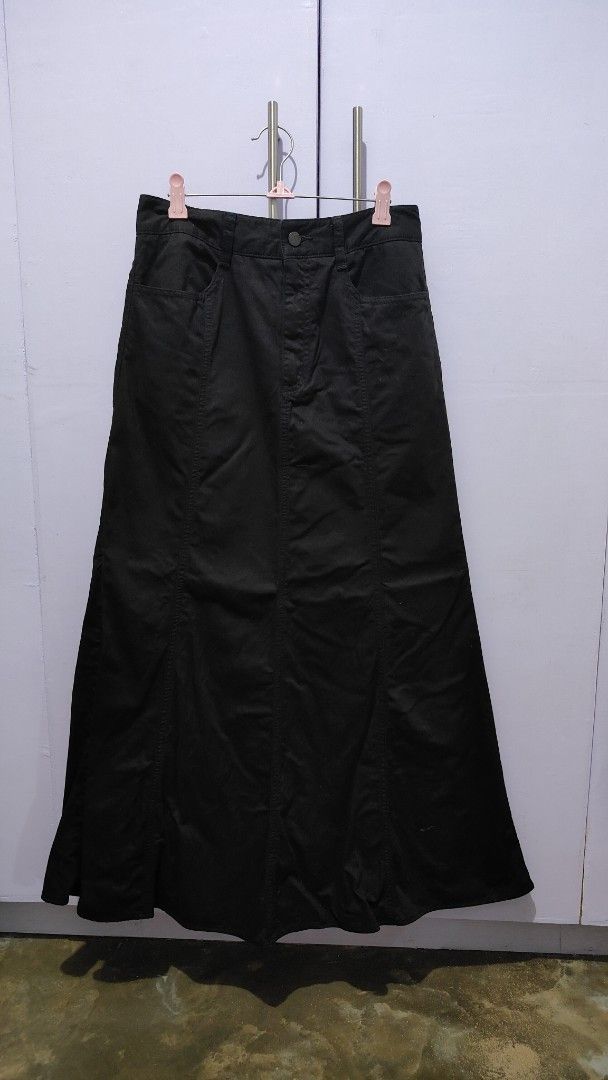 GU Black Long Maxi Skirt (Category: Skirts) located in Bacolor. Submitted by annjjjjj (Listing ID 1467099633, Image 1). Description: - Color: Classic black - Style: Long maxi skirt with a chic flared mermaid hem and front panel stitching - Fit: Structured waistband with secure button closure - Features: Functional and deep pockets on both sides - Material: Sturdy, high-quality, cotton-like feel - Versatility: Great basic piece that is easy to mat
