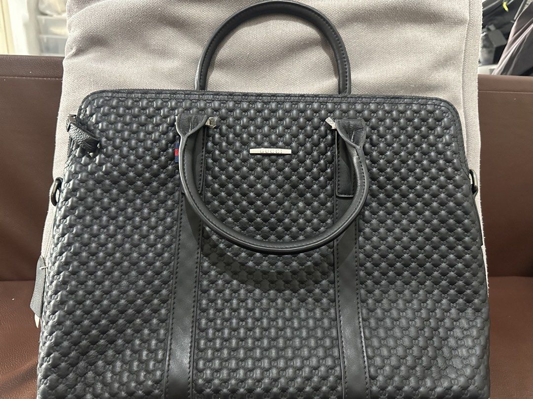 Gucci Black Leather Embossed Briefcase Laptop Bag (Category: Briefcases) located in Manila. Submitted by cbnarciso (Listing ID 1466984652, Image 1). Description: - Brand: Gucci - Material: Premium black leather with debossed GG monogram - Hardware: Silver-tone with Gucci metal plaque - Interior: Black and white striped fabric lining with zip pocket and dedicated laptop compartment - Closure: Secure main zippered closure with double top carry hand
