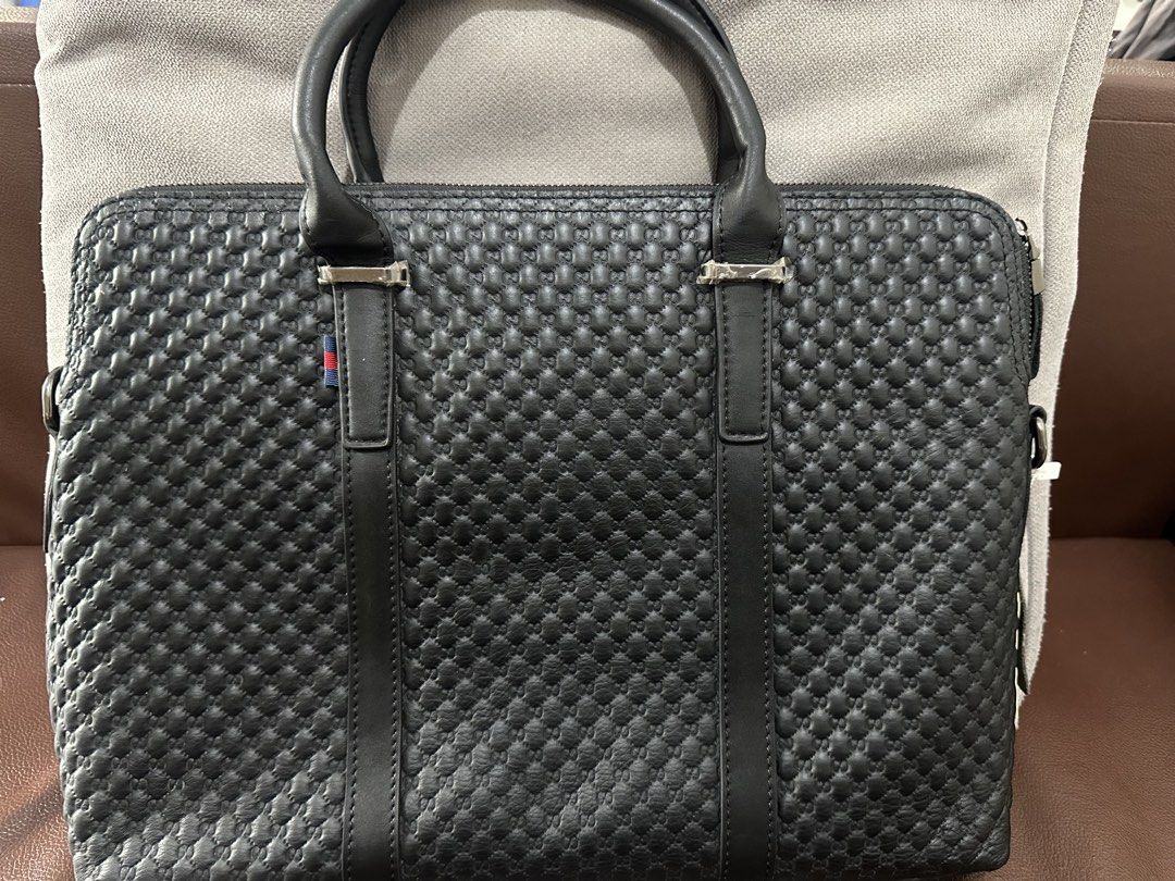 Gucci Black Leather Embossed Briefcase Laptop Bag (Category: Briefcases) located in Manila. Submitted by cbnarciso (Listing ID 1466984652, Image 2). Description: - Brand: Gucci - Material: Premium black leather with debossed GG monogram - Hardware: Silver-tone with Gucci metal plaque - Interior: Black and white striped fabric lining with zip pocket and dedicated laptop compartment - Closure: Secure main zippered closure with double top carry hand