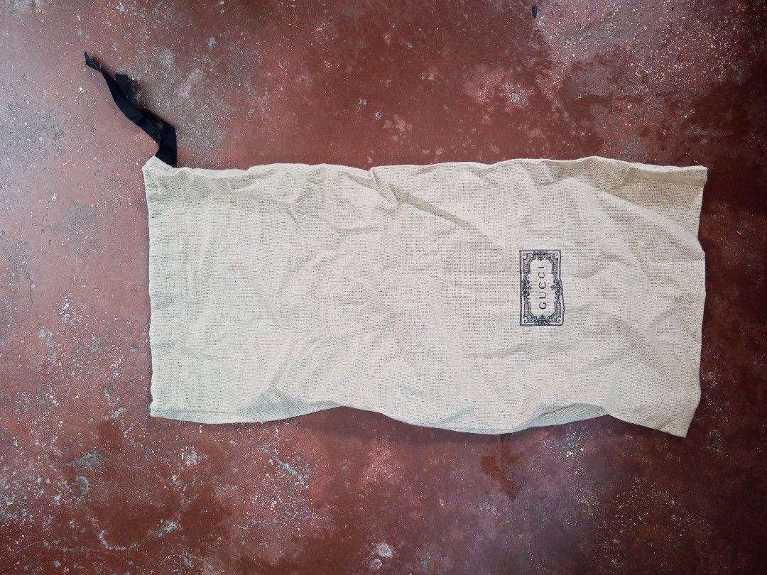 Gucci branded dust bag with drawstring (Category: Luxury Bags & Wallets) located in Lucban. Submitted by aeronroyyy (Listing ID 1466986656, Image 3). Description: - 100% Authentic Gucci dust bag - Material: 88% cotton, 12% polyester - Color: Beige with a vintage-style black Gucci logo on the front - Closure: Secure black drawstring at the top - Care: Includes stitched-in interior care label with washing instructions - Condition: Excellent/Pristin