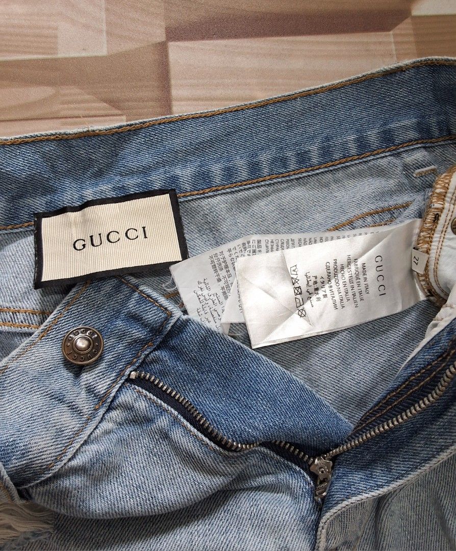 Gucci Denim Short (Category: Shorts) located in Makati City. Submitted by justget8 (Listing ID 1467126707, Image 3). Description: - Size: W-25-27 L-14 - Details: Distressed accents on front and back pockets - Accents: Adorable black embroidered cat patch with blue bow on the right back pocket - Branding: Authentic leather Gucci logo patch on the back waistband - Closure: Metal button and front zipper.