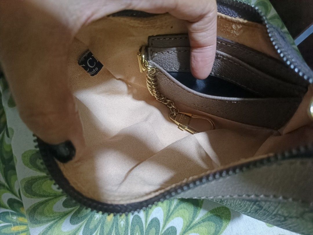 Gucci GG Supreme Canvas Mini Hobo Bag (Category: Luxury Bags & Wallets) located in Cebu City. Submitted by elen30abalo (Listing ID 1467083887, Image 2). Description: - Gucci mini hobo bag - Beige GG supreme canvas with taupe leather trim - Curved half-moon shape with zip top closure - Light pink interior lining with card slots - Attached gold-tone key chain clip - Made in Italy stamp embossed inside - Compact size, ideal for essentials.
