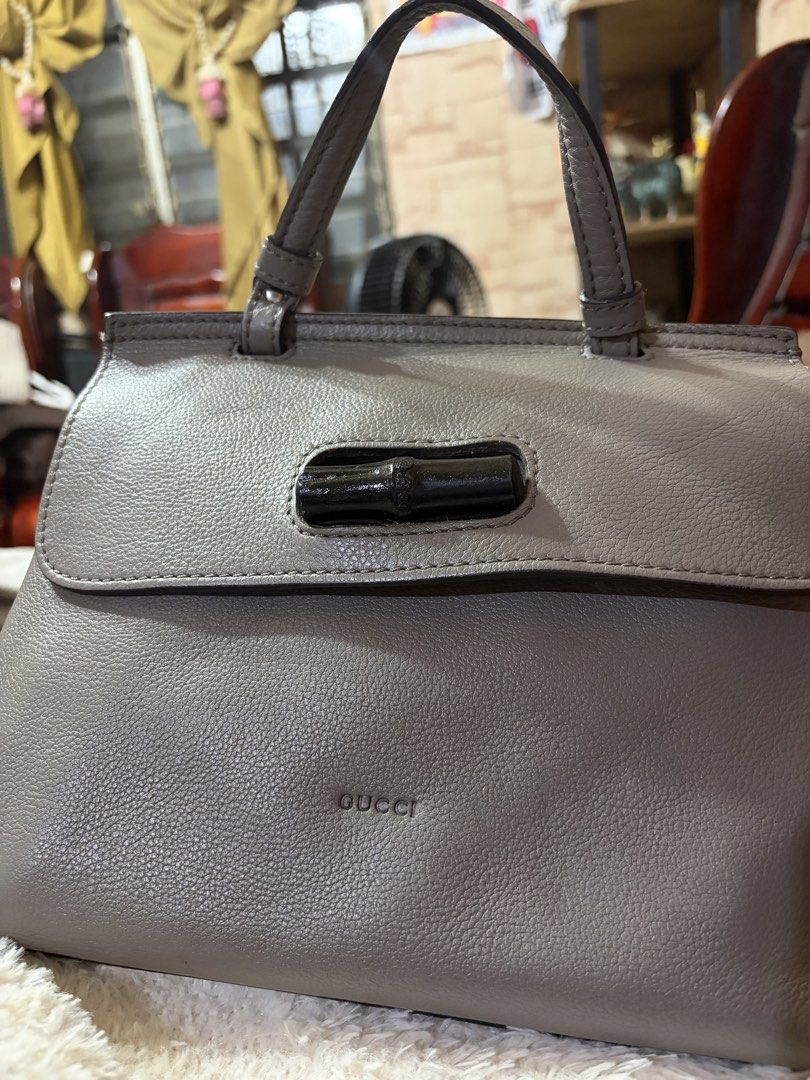 Authentic Gucci Grey Leather Bamboo Top Handle Bag (Category: Luxury Bags & Wallets) located in Manila. Submitted by lynnalec25 (Listing ID 1467146214, Image 1). Description: - Brand: Gucci - Material: Premium grey pebbled leather with silver-toned hardware - Closure: Signature bamboo turn-lock on front flap - Straps: Dual top handles and a detachable, adjustable shoulder strap - Design: Structured silhouette, clean stitching, and debossed Gucci 