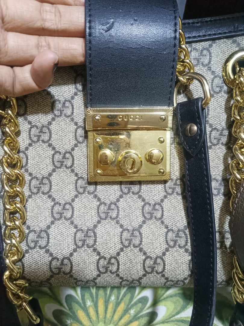 Gucci Padlock GG Supreme Small Shoulder Bag (Category: Luxury Bags & Wallets) located in Cebu City. Submitted by elen30abalo (Listing ID 1467084013, Image 2). Description: -Gucci shoulder bag in iconic GG Supreme canvas - Elegant black leather top flap with secure gold-tone lock closure - Stylish chain shoulder strap for versatile wear - Clean beige suede interior lining featuring convenient open slip pockets - Condition: Minor cracking/wear on t