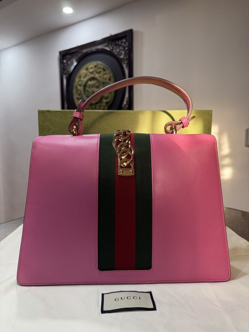 Gucci Pink Sylvie Medium Top Handle Shoulder Bag (Category: Luxury Bags & Wallets) located in Ilagan. Submitted by stargirldotph (Listing ID 1467098554, Image 2). Description: • ₱45,459 ONLY • Retail Price: $2,496 • Guaranteed Authentic • USED, but still very presentable, and ready to use. In excellent condition. • No major issues to mention. Please inspect all the photos. • Inclusions: Box, Dustbag • PM me for more inquiries WHAT YOU SEE IS WHAT