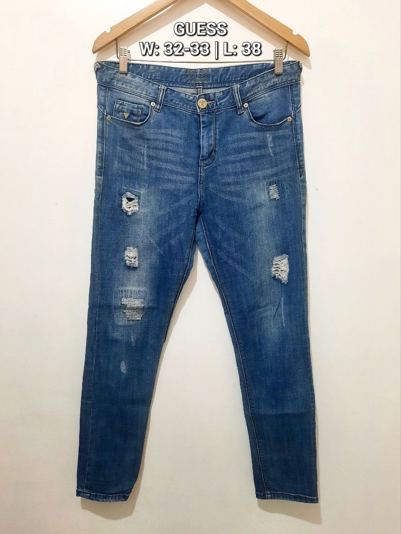 Guess Distressed Blue Denim Jeans (Category: Jeans) located in Cavite. Submitted by YANAminicloset (Listing ID 1467167311, Image 1). Description: - Brand: Guess - Color/Wash: Blue mid-wash with whiskering - Style: Distressed with knee rips - Closure: Standard button and zip fly - Features: Belt loops, classic casual denim design - Waist: 32-33 inches - Length: 38 inches.