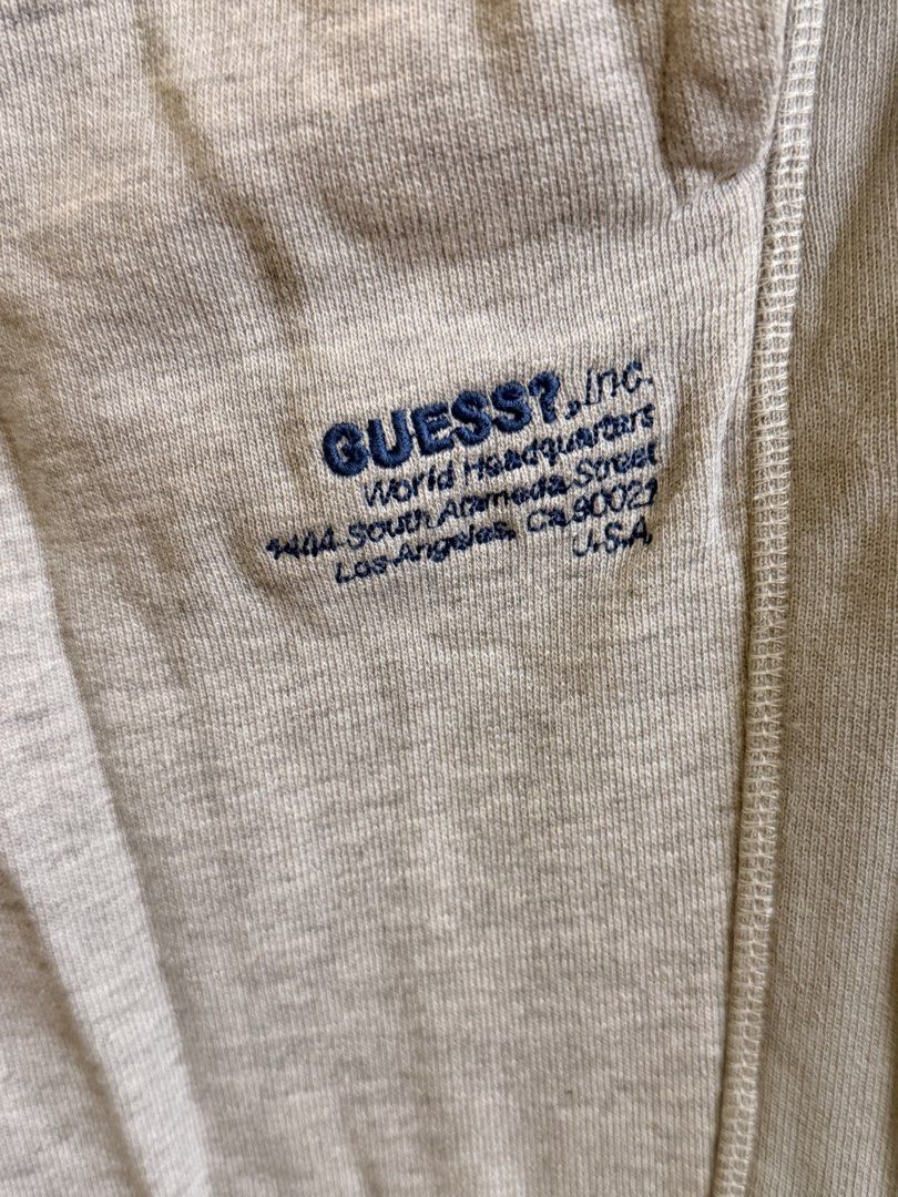 Guess Grey Regular Fit Sweatpants (Category: Joggers) located in Manila. Submitted by lanzblade (Listing ID 1467063600, Image 2). Description: - Brand/Style: Guess regular-fit grey sweatpants - Waist: Drawstring waist with metal aglets - Details: Small blue embroidered logo and address text on the front left leg - Pockets: Convenient side pockets and a single welt pocket on the back right - Cuffs: Ribbed cuffs at the ankles - Material: Soft cotto