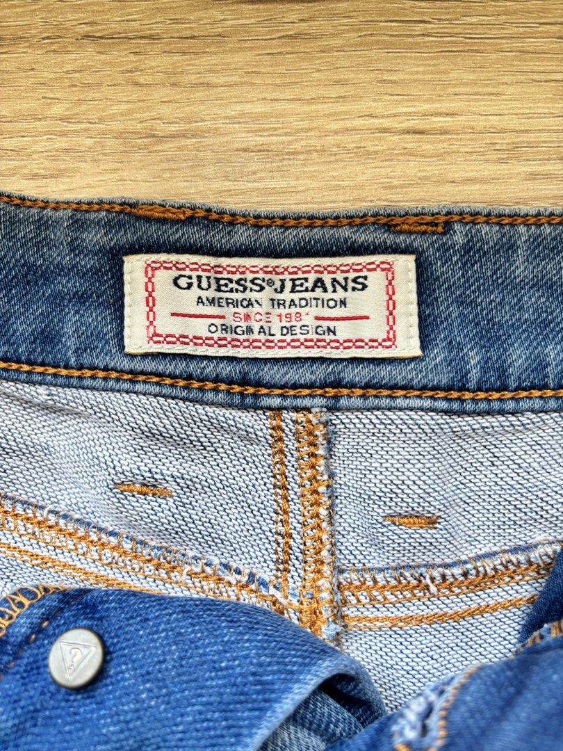 Guess Jeans Denim Shorts Size 27 (Category: Shorts) located in Paranaque City. Submitted by ggg.bin (Listing ID 1466976278, Image 3). Description: - Brand: Guess - Style: Classic blue wash denim shorts with button fly - Size: 27 - Details: Raw frayed hem edge, branded metal hardware, and iconic back pocket logo patch - Condition: Great everyday staple for warm weather.