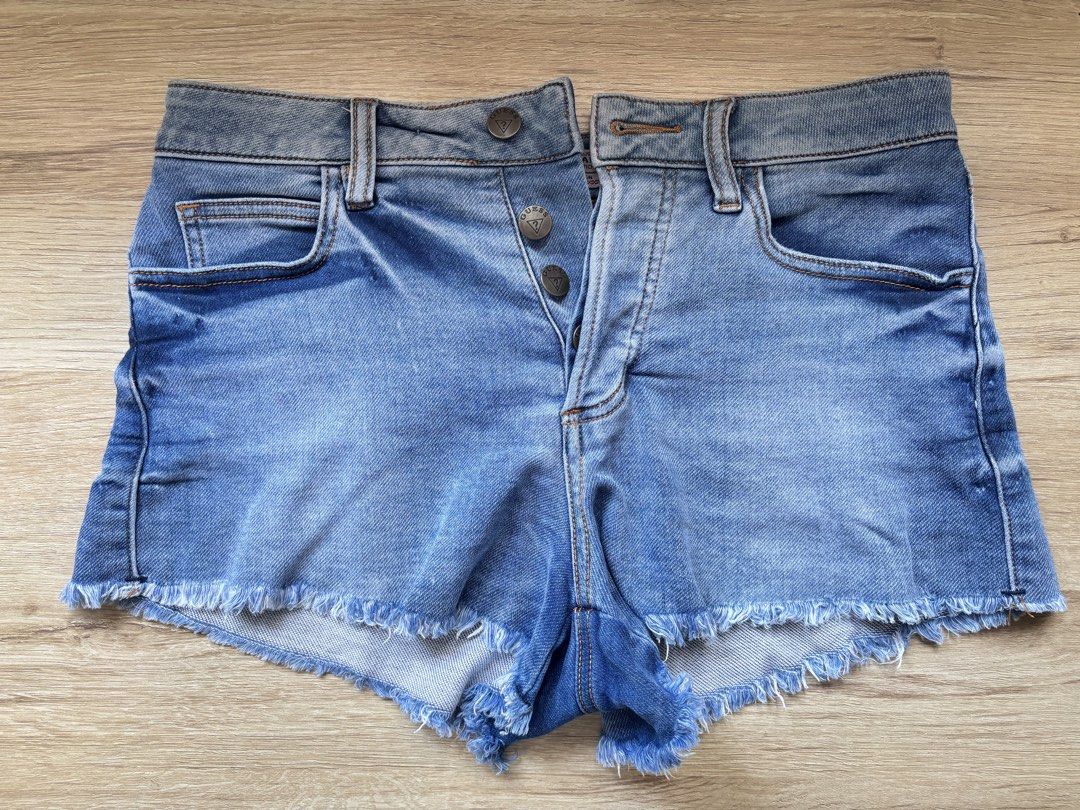 Guess Jeans Denim Shorts Size 27 (Category: Shorts) located in Paranaque City. Submitted by ggg.bin (Listing ID 1466976278, Image 1). Description: - Brand: Guess - Style: Classic blue wash denim shorts with button fly - Size: 27 - Details: Raw frayed hem edge, branded metal hardware, and iconic back pocket logo patch - Condition: Great everyday staple for warm weather.