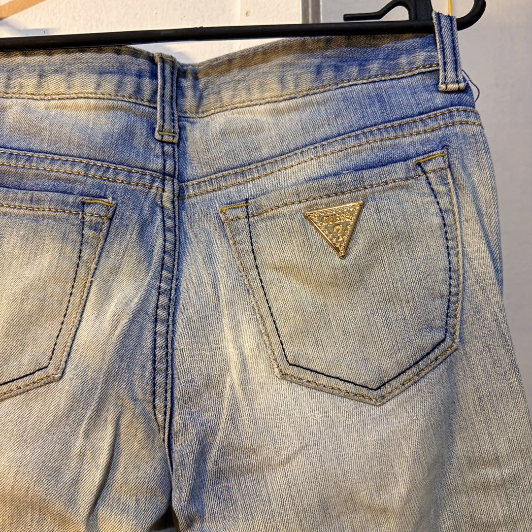 Guess Jeans Since 1981 Distressed Light Wash Denim (Category: Jeans) located in Paranaque City. Submitted by capybara808 (Listing ID 1467094443, Image 3). Description: - Brand: Guess - Wash: Light wash denim with natural whiskering effects - Fit: Mid-rise with classic 5-pocket styling - Details: Distressed knees, gold button closure, and signature inner waistband logo embroidery - Hardware: Iconic metal triangle logo plaque on the back pocket - C