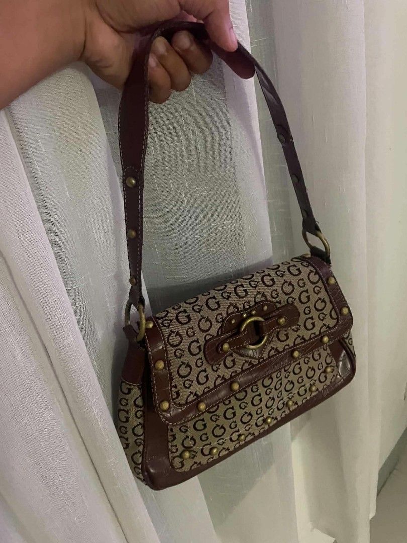 Guess Monogram Shoulder Bag Brown (Category: Shoulder Bags) located in Cainta. Submitted by mariss.luxx (Listing ID 1467078551, Image 1). Description: - vintage-style Guess shoulder bag - Brown all-over monogram print with chic faux-croc trim - Antique brass-tone hardware, metal studs, and front buckle detail - Comfortable single shoulder strap with contrast stitching - Secure top-zip closure - Clean interior with Guess logo lining and brand patc