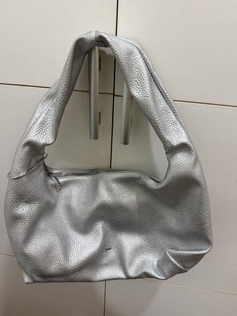 GVN Medium Hobo Bag (Silver) (Category: Shoulder Bags) located in Davao. Submitted by pamdyclutters (Listing ID 1467136730, Image 1). Description: - Color/Finish: Trendy silver metallic with a pebbled texture - Style: Slouchy hobo with a thick strap and chic metal ring detail - Closure: Top zip closure to keep your belongings secure - Interior: Clean white lining with a convenient zipped side pocket for small essentials - Practicality: Lightweigh